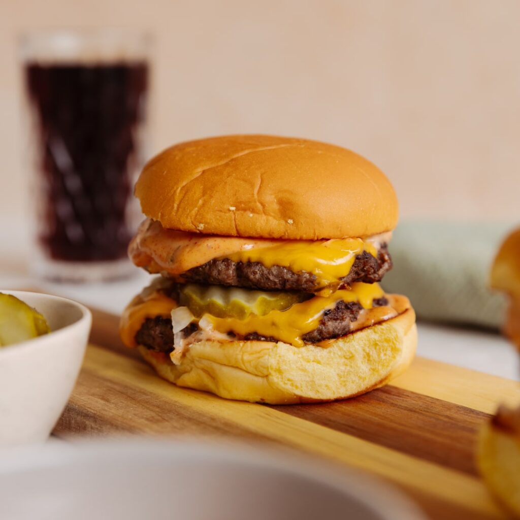 Close-up of a juicy double cheeseburger, part of an easy 10-minute recipe from Lamanna.