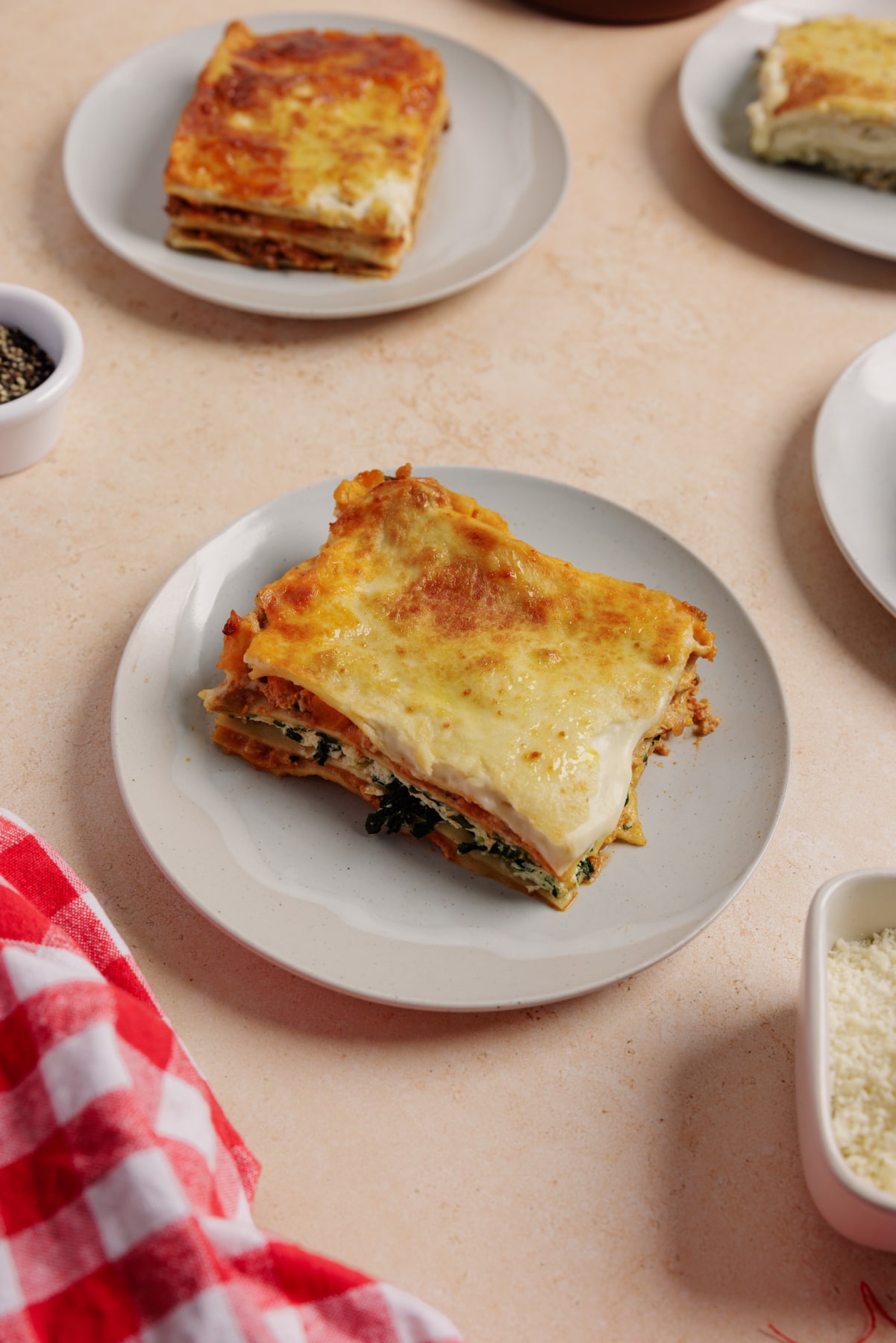 chicken, spinach and ricotta lasagne on a white plate
