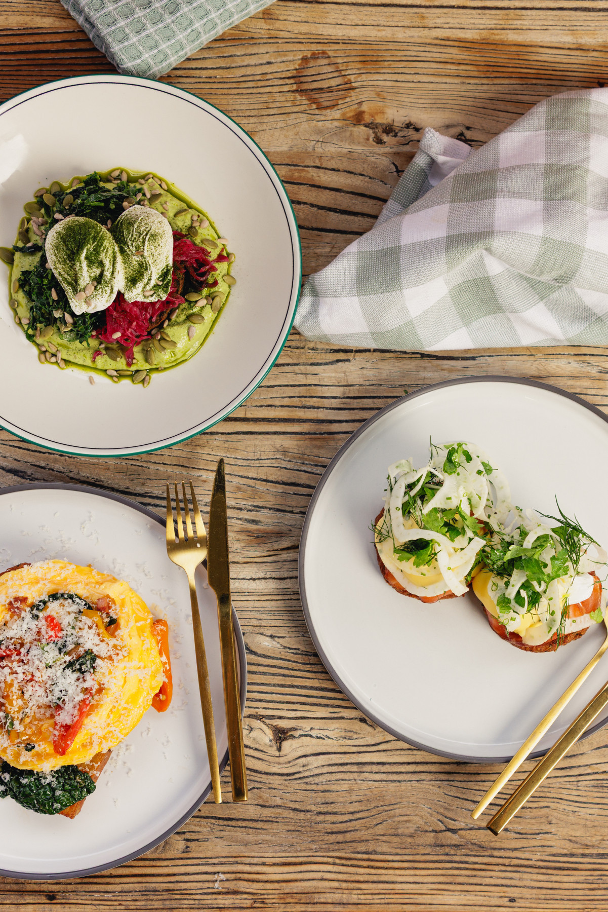 Assorted breakfast at LaManna Café Essendon Fields including greens bowl with eggs, eggs royale with salmon, and chilli scramble