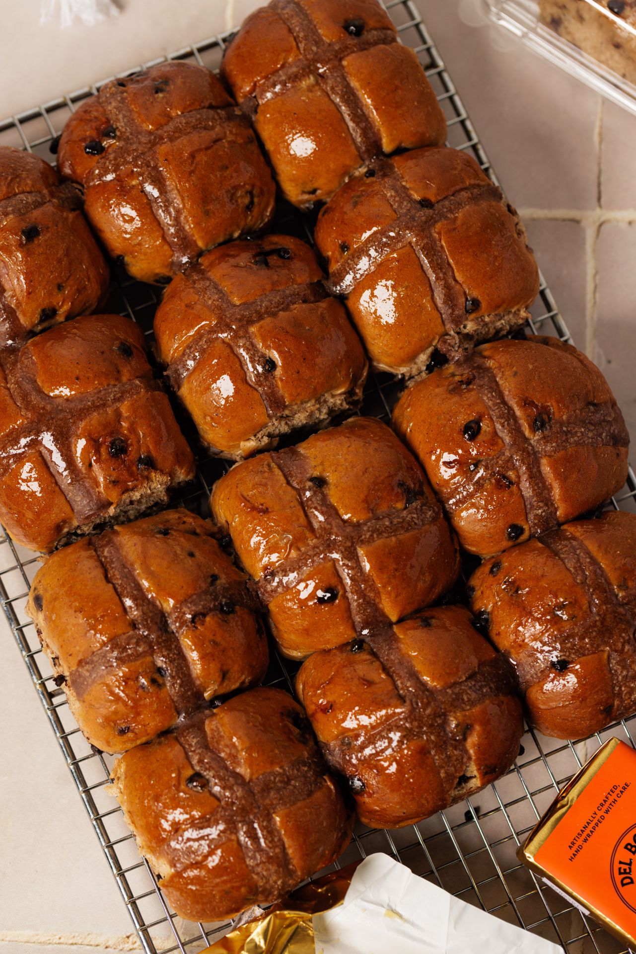 Freshly baked hot cross buns arranged neatly.