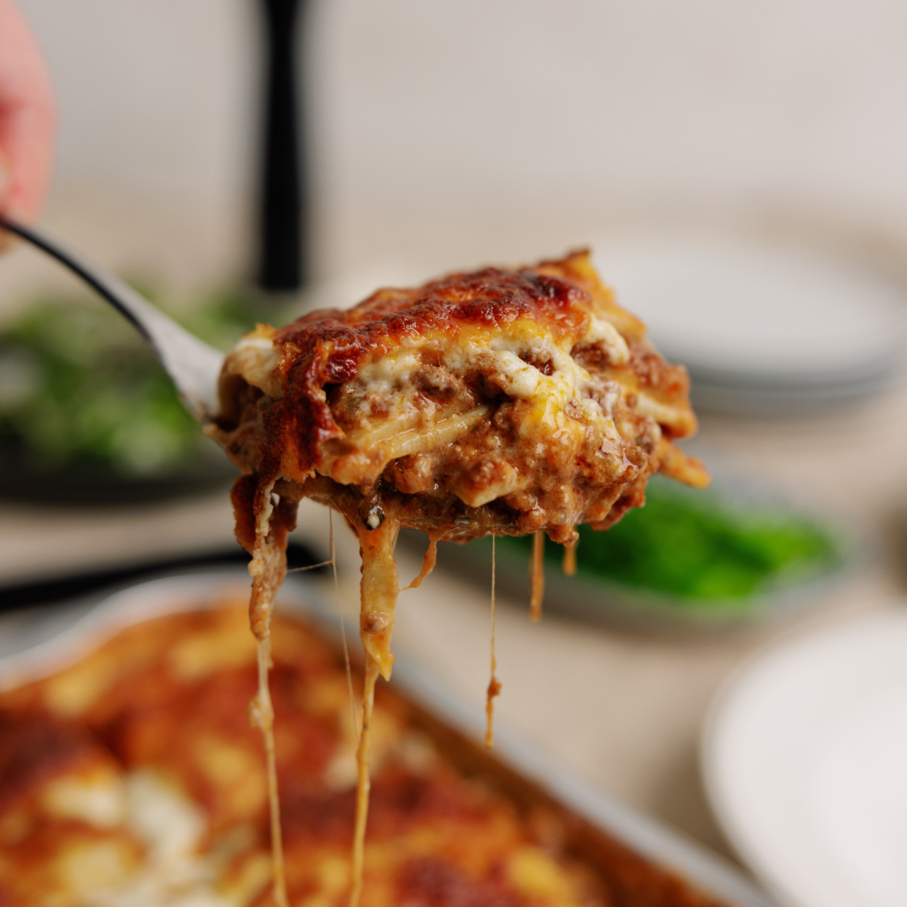 piece of lasagna on a spoon lifted