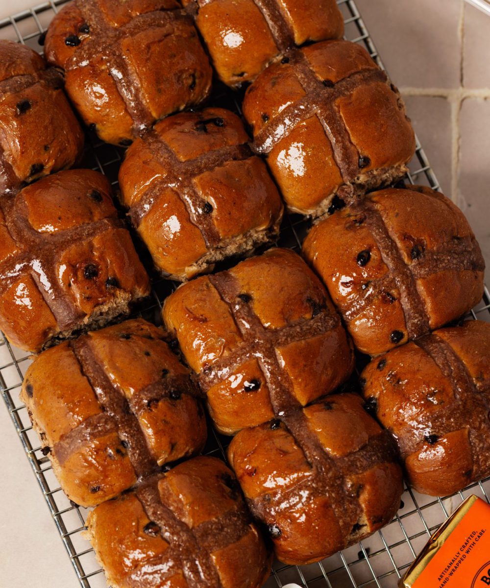 Freshly baked hot cross buns arranged neatly.